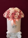 Rosé Amour luxury round flower box filled with blush pink, dusty rose and ivory roses with a blush satin ribbon