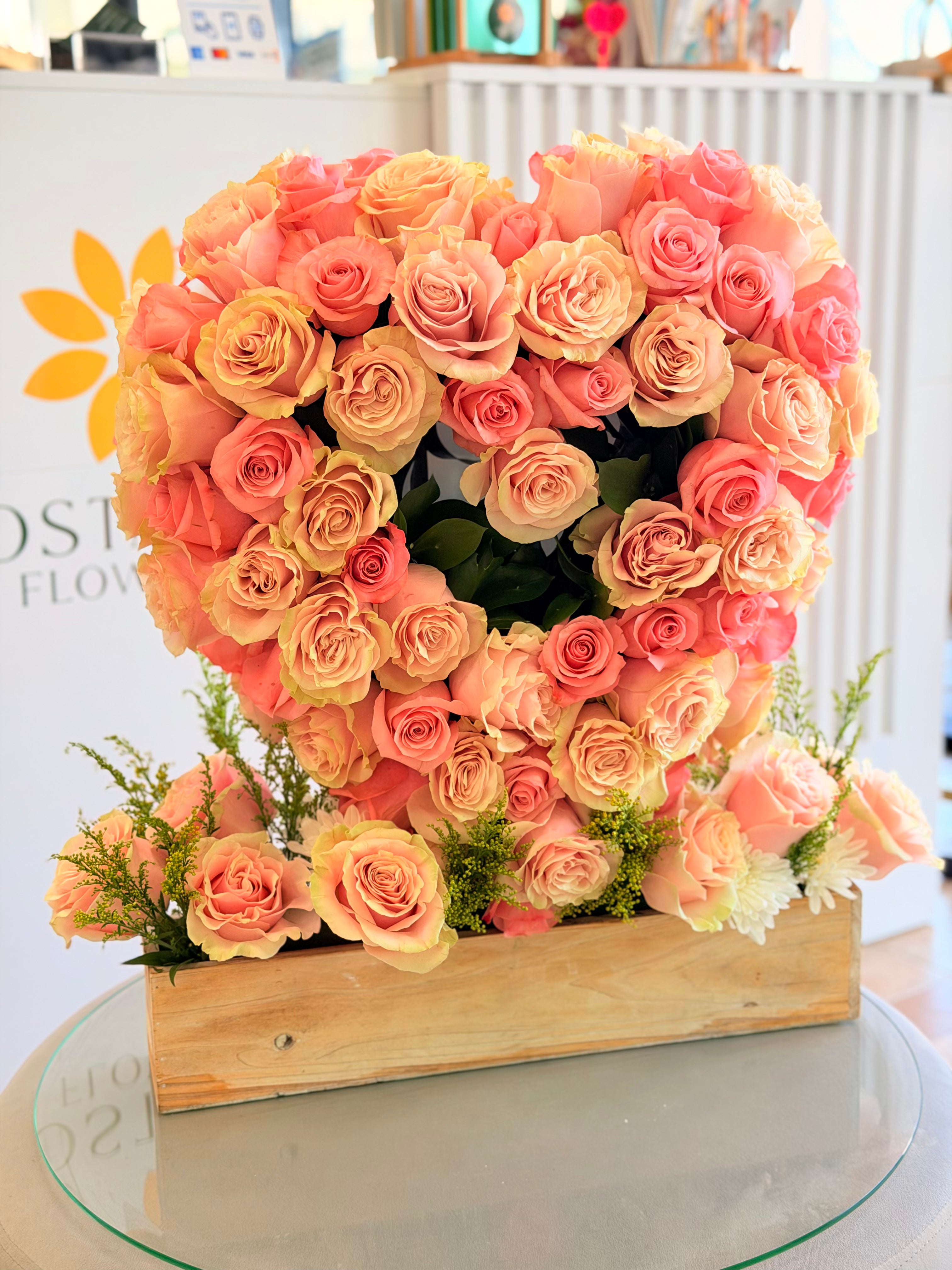 Heart of Roses Arrangement with luxury peach coral and blush roses in an open heart design
