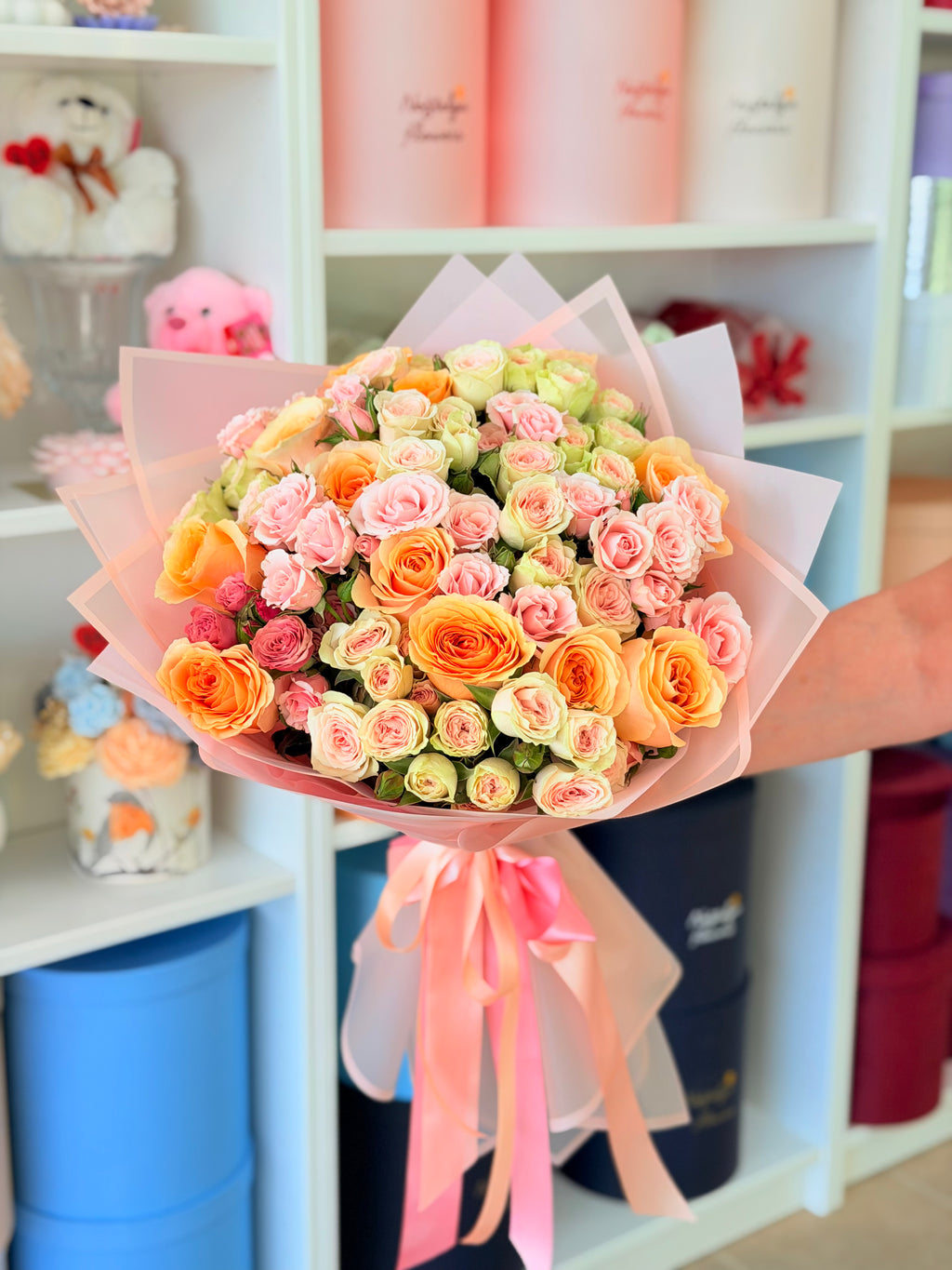 Peach and pink rose bouquet with pastel wrapping for flower delivery in Los Angeles